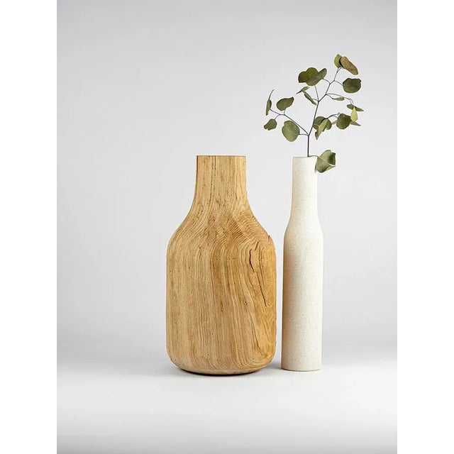 A collection of Vicenza stone vases and walnut wood, beech, tinker and chestnut that arises from the theme of the...