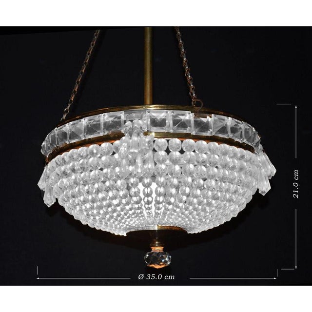 An elegant French Art Deco crystal basket chandelier dating to circa 1930, distinguished by its elaborate arrangement of...