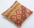A one-of-a-kind handwoven Afghan wool kilim accent pillow featuring split design of gold stripes and a red diamond grid....