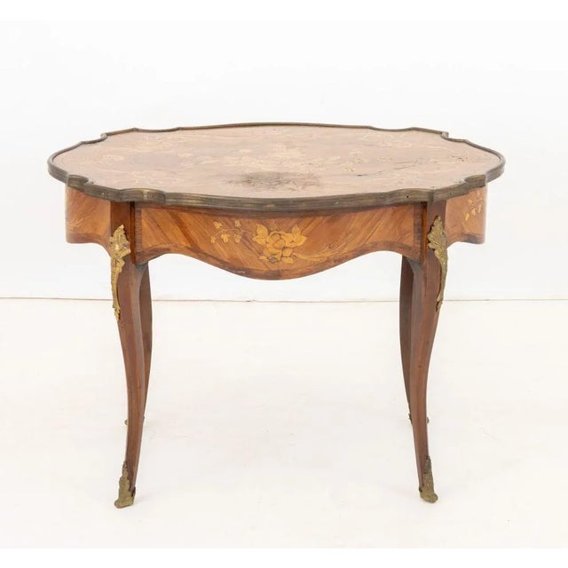Louis XV Style Kingwood Marquetry Coffee Table, the inlaid top with ormolu mounted rim above four cabriole legs with...