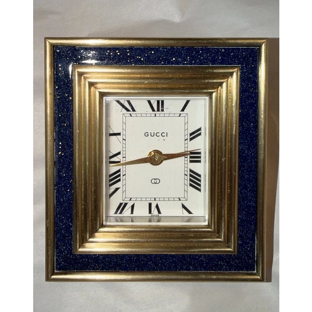This listing is for a vintage Gucci desk clock. The clock dates to the 1960s and features a blue lapis lazuli frame with...