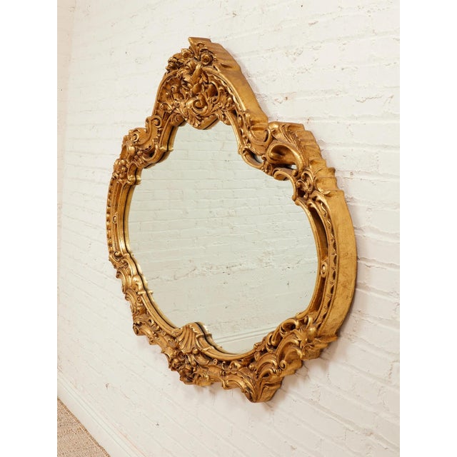 Louis XV Style Gilt Wall Mirror with Rococo Carved Floral Frame is Inspired by simple, minimalist forms, this vintage...