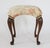 Vintage Queen Anne-style footstool featuring an elegant floral upholstered seat and curved cabriole legs. No makers mark....