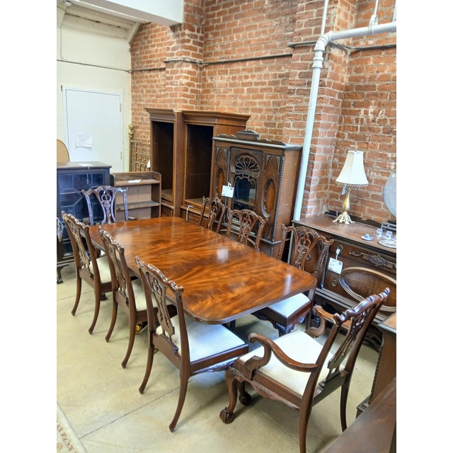 Maitland-Smith dining table and chairs set. Includes table, eight chairs, two table leaves, and a table pad set.