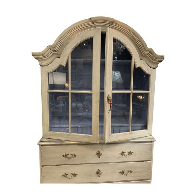 A substantial late c18th domed top two part Swedish cabinet/vitrine with panelled glazed doors and three long deep drawers...