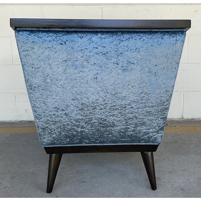 This stylish modern lounge chair is inspired my origami, the frame is an espressos finished wood. The seat is a woven...