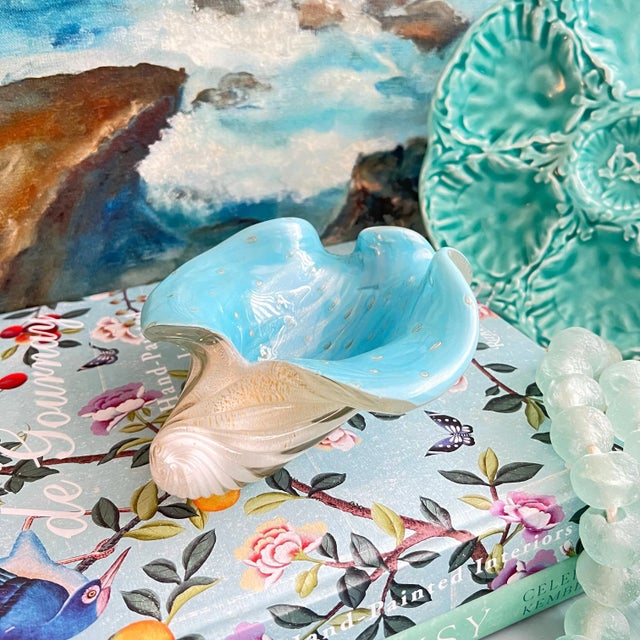 A blue and gold Murano attributed hand blown art glass sea shell with Bullicante (controlled bubble) design. The interior...