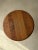The strength of this small table lies primarily in its form. A round top with a full, rounded edge rests on a central...