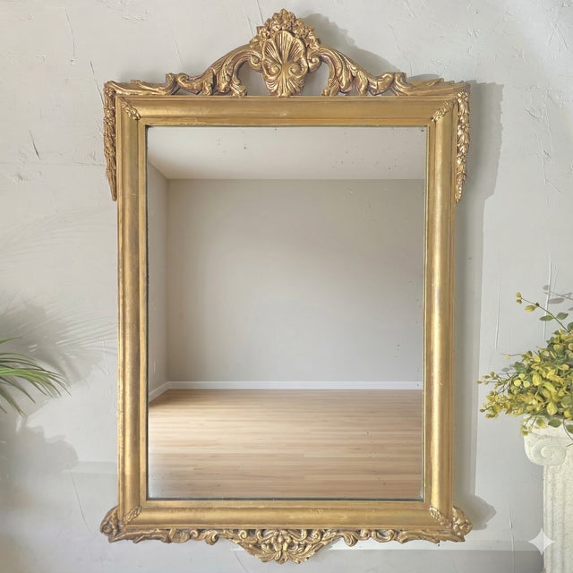 Item Description Elevate your interior with this stunning antique mirror featuring a gesso over wood frame in the lavish...