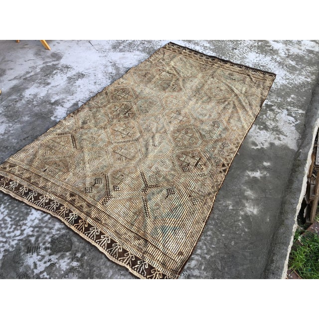 This is a vintage Turkish Anatolian kilim rug from the 1960s. The piece was hand-woven.