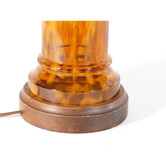 The warm amber glass with darker patches diffuses light in a captivating, inviting manner, creating a cozy atmosphere that...