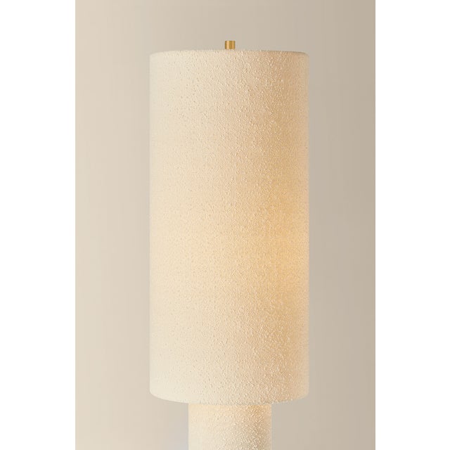 The all-over soft ivory boucle of the Sam family of lamps creates an inviting addition to modern interiors. As a table...