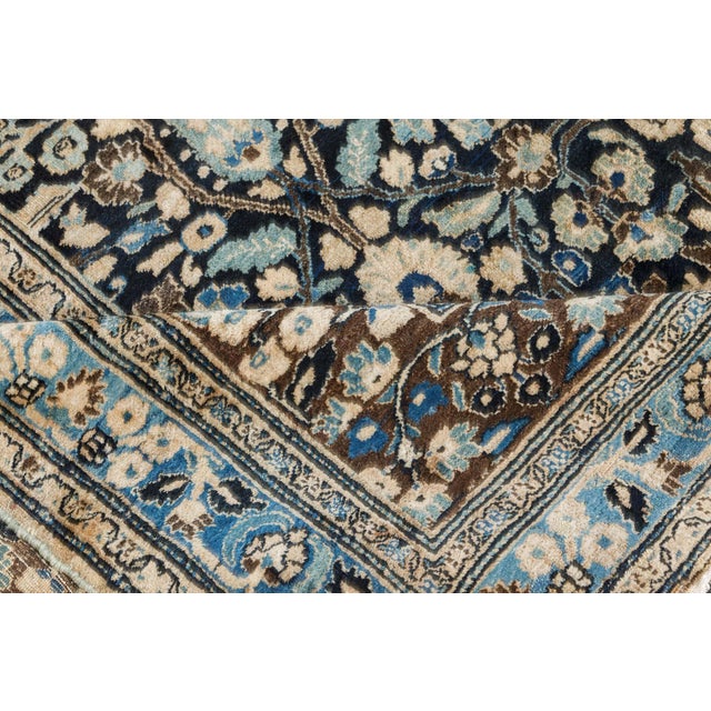 A late 19th century antique Persian Meshad (Meshed) antique rug, the midnight field with an allover dense design of rows...