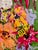 A joyful garden alive with flowers, butterflies, a busy bee and a bright yellow bird. Rich color and expressive brushwork...