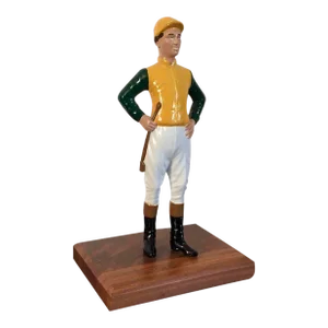 Iron Desk Top Statue of a Horse Jockey Dressed in Silks, Cap, Jodhpurs, Boots and Carrying a Riding Crop Mounted on Mahogany Base Door Stop