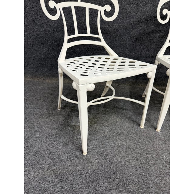 Set of four white powder-coated outdoor bistro chairs with lattice and scroll back design. Suitable for indoor or outdoor....