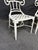 Set of four white powder-coated outdoor bistro chairs with lattice and scroll back design. Suitable for indoor or outdoor....