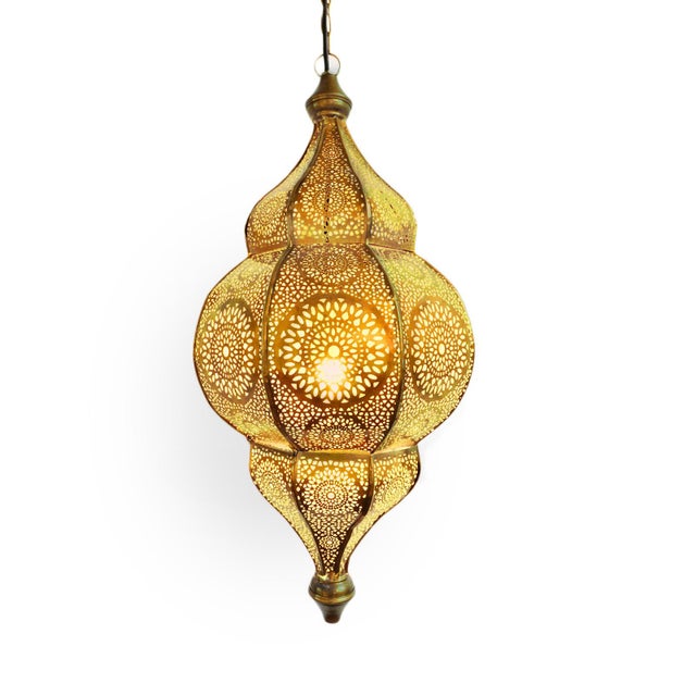 Beautiful Moorish brass hanging lantern with yellow glow from the interior which is painted. The exterior is perforated...
