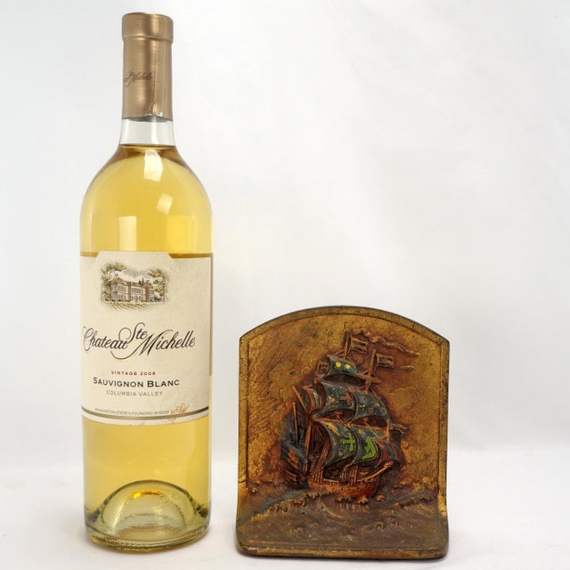 A colorful and deeply cast polychrome cast iron single bookend by Littco with a design of a galleon in wind and waves. The...