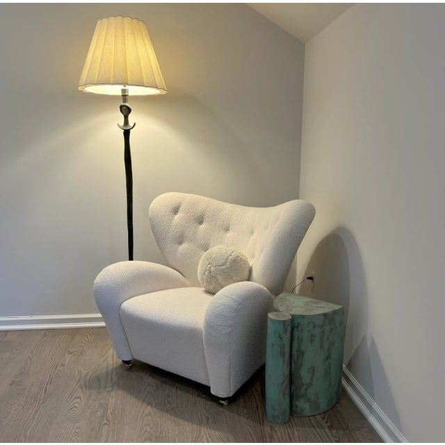 Iconic Tired Man chair designed by Flemming Lassen and produced by Audo Copenhagen. This version features Audo's Barnum...