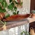 This exquisite African Carved Wooden Paddle Bowl with Handles is a stunning blend of artistry and functionality, perfect...