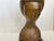 This is a bronze colored bust of a woman with a stylized Japanese hairstyle, likely from the mid-century era, but unsure...