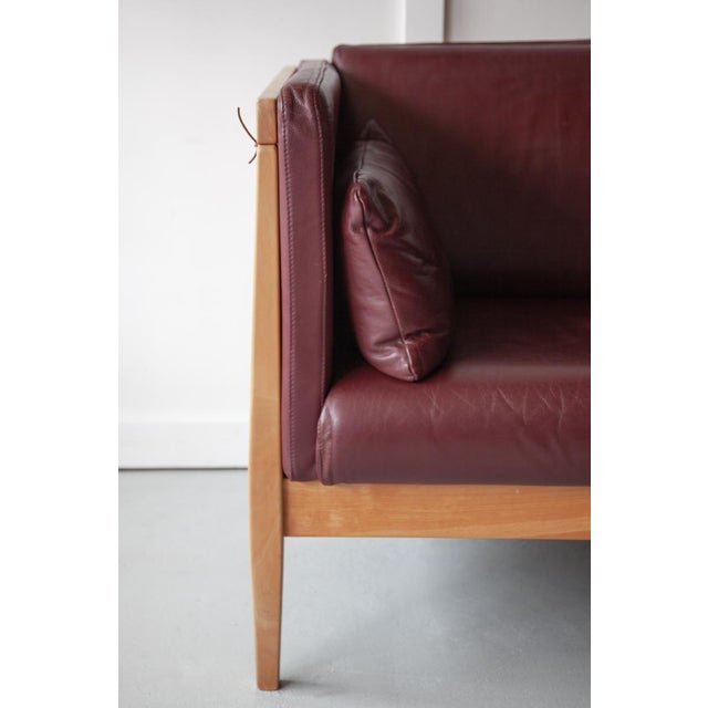 A wonderful Danish two seater sofa, in the style of Andreas Hansen, with a stylish, slatted beech frame and leather...
