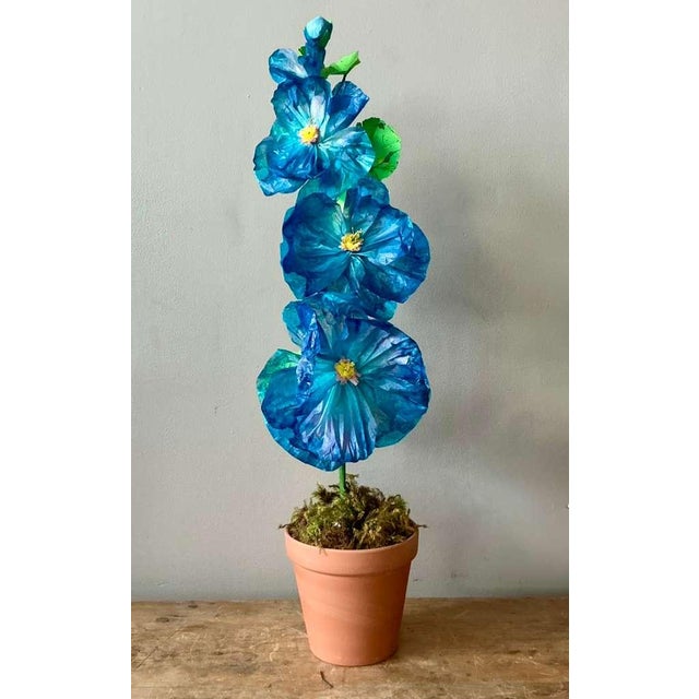 Contemporary hand-rolled paper flowers are a modern, artistic take on traditional floral arrangements. These flowers are...