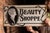 Double-sided porcelain enamel projecting trade sign for a beauty shop, featuring a striking Art Deco portrait of a...