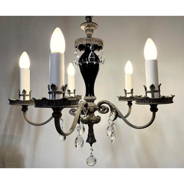 This elegantly refined chandelier is 21" wide, its main body is 24" tall. It comes with an old, ornate, dark cast brass 6"...