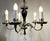 This elegantly refined chandelier is 21" wide, its main body is 24" tall. It comes with an old, ornate, dark cast brass 6"...