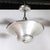 This streamlined Art Deco Machine Age Brushed Aluminum Pendant Chandelier signed Edwin Guff originated in the United...