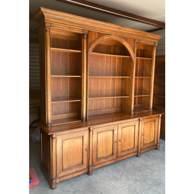 Large Henredon Avignon cherry wall unit with bookcase shelving and cabinet storage. A refined traditional case piece with...
