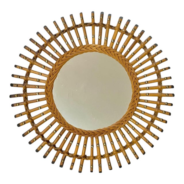 Mid century bamboo sunburst mirror with brass accents and beaded wicker frame. This mirror is slightly unusual because of...