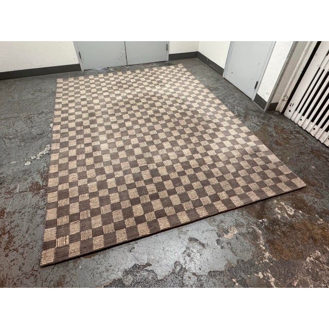 Design Plus Gallery presents a 8ft 6in × 11ft 7in Contemporary Checkered Hand Tufted Wool Area Rug. The rug has a taupe...