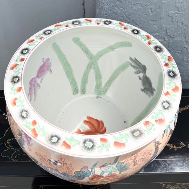 Beautiful vintage Chinese porcelain fish bowl featuring an elaborate hand-painted design in a soft famille rose-inspired...