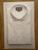 A simple crisp white shirt, neatly folded in a reproduction print made by the artist’s studio based on his original...