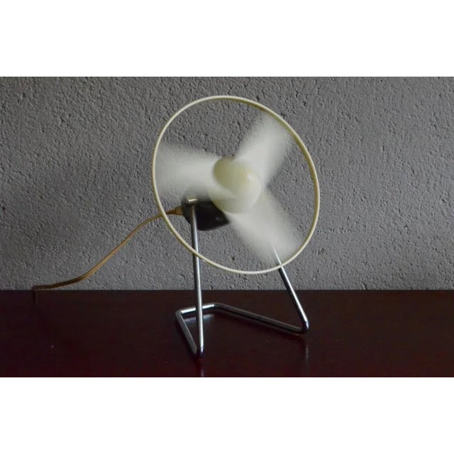 This table fan was produced by French company Calor in the 1950s or 1960s. The fan features molded plastic blades and a...