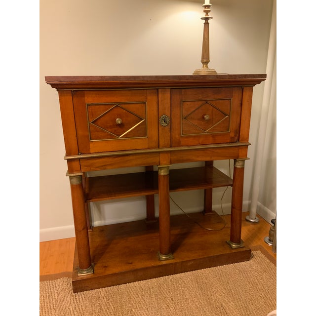 A handsome early-19th-century French document cabinet, or cartonnier, in richly figured mahogany with crisp brass...