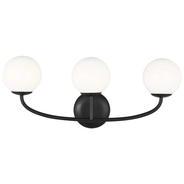 The Galassia three light wall sconce by AERIN in midnight black perfectly balances a glass globe and curving teardrop...