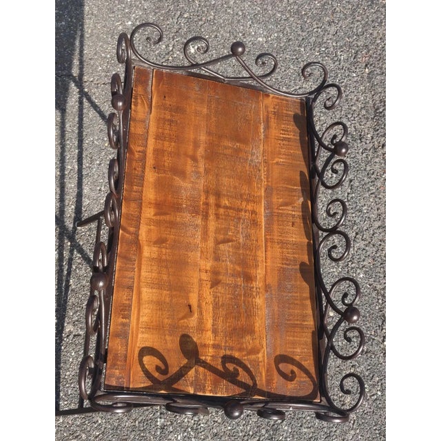 Antique finish butler's tray table with ornate edging. Dimensions: L24 W15.5 H27in Material: Metal Colour: Brown