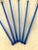Retro set of six plastic clear blue swizzle sticks each featuring a colorful topper replica of a tropical cocktail....
