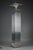 Floor lamp forming a column whose body is made up of glass tubes set on a brass base and topped by a glass shade forming a...