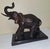 A striking bronze sculpture of an elephant, presented on a solid marble base. Measuring 14" x 6.5" x 12", this piece...