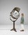 Oversized studio spotlight lamp on a tripod stand in Aged Brass and Bronze. Finished in aged brass and bronze, this...