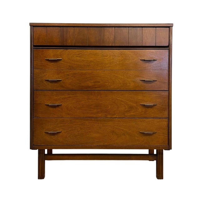 Mid century modern four-drawer dresser manufactured by Bassett Furniture Industries, Inc. This piece features a clean,...