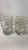 Set of 4 vintage glasses with white floral detail and gold stripe. Some have original label indicating they are unused....