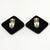 Large square earrings made of black resin embellished with clear baguette rhinestones in a Deco revival style. We believe...