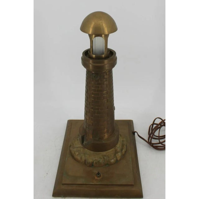 A very special, large brass table lamp in the form of a lighthouse. There are no manufacturer's markings or other marks on...