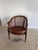 Charming French Louis XVI Style Cane Armchair, circa early 20th century. Features a hand-carved walnut frame with fluted...